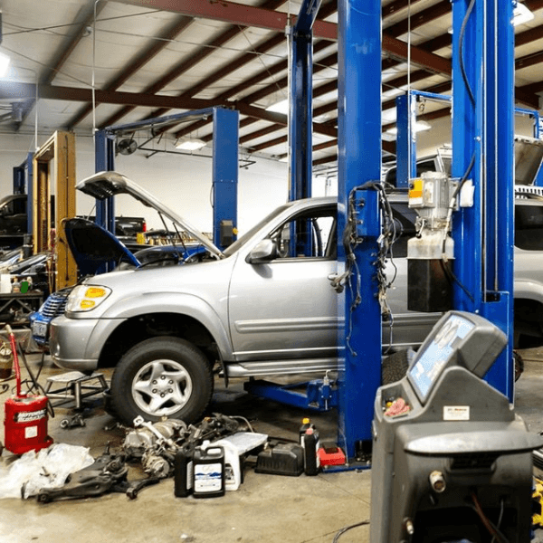 Silver SUV on a lift in the Sherwood Auto Repair shop