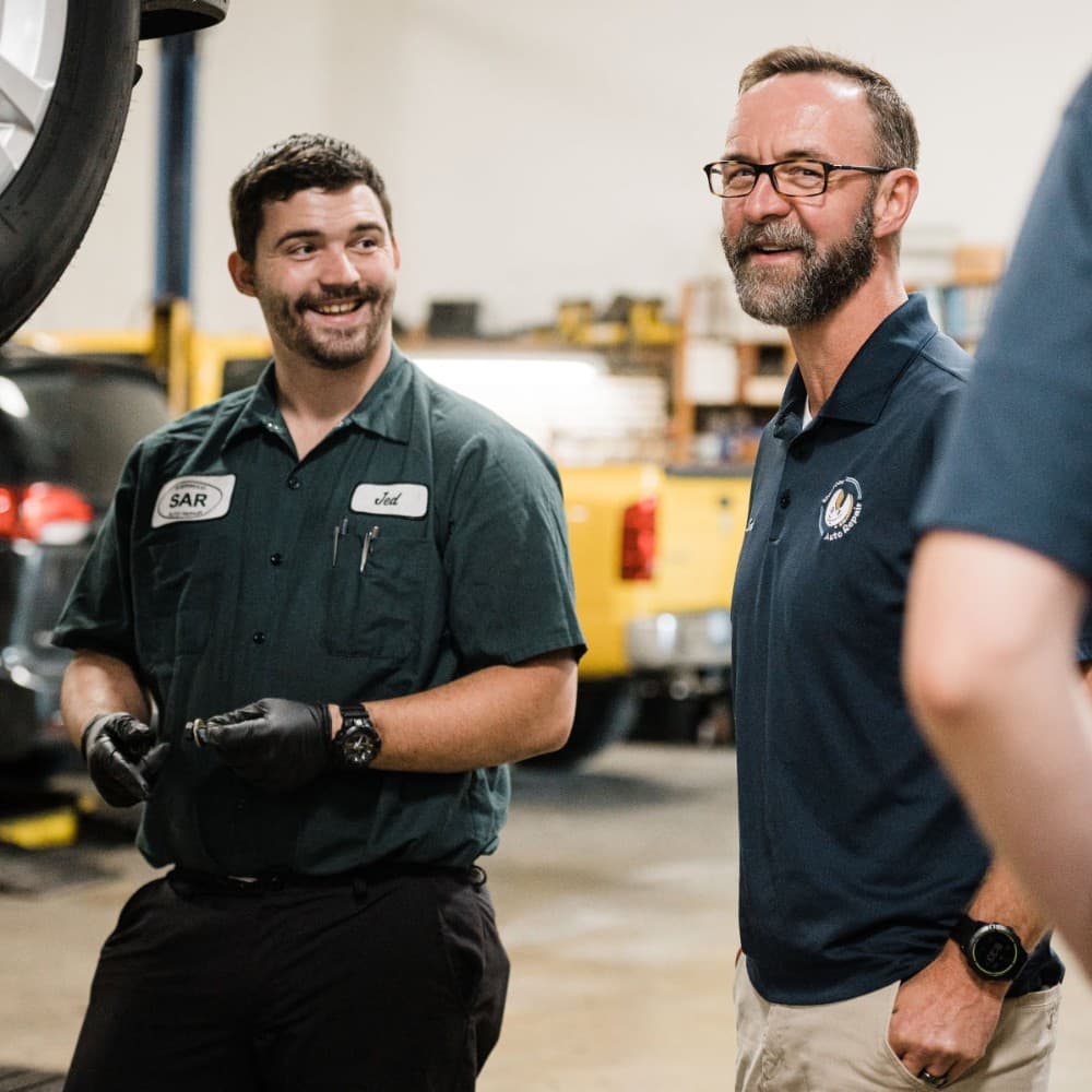 Jed and Scott laughing together in the garage
